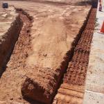 Retaining wall trenching