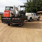 Bobcat S70 and Excavator all on dump trailer along with appropriate attachments for each job.